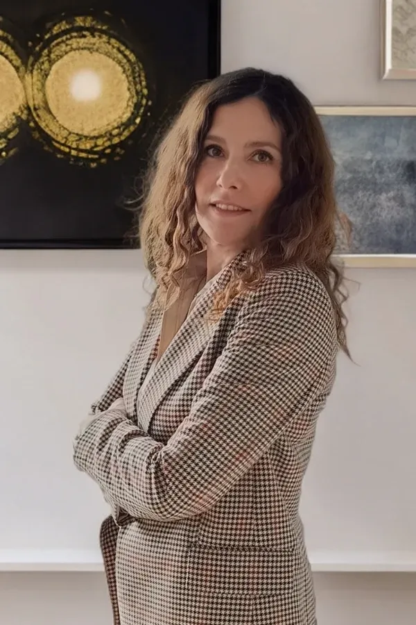 Louisa Savva, founder of Pursue Your Potential, standing with arms folded